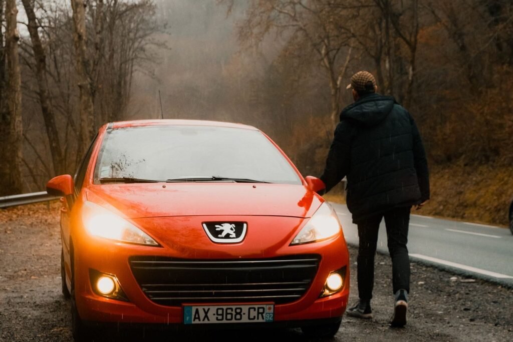 Peugeot orange de face sur une route de campagne
